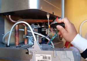 engineer checking faulty boiler