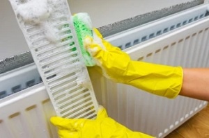 man cleaning radiator