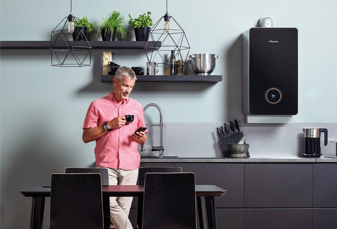 man in kitchen with boiler installed
