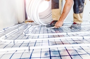 man installing underfloor heating