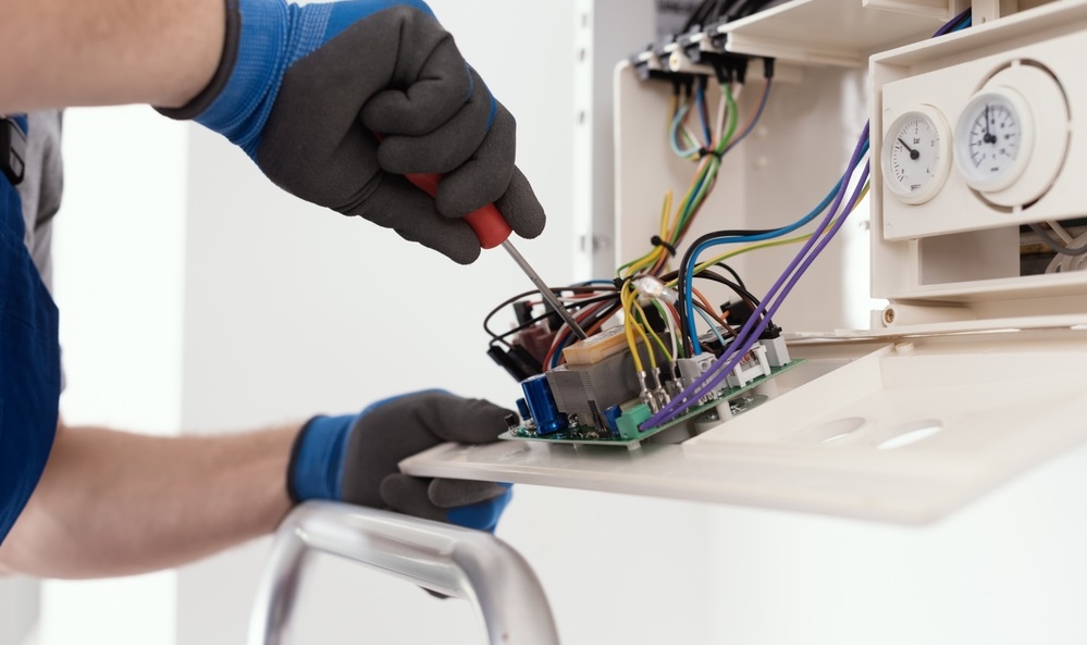 qualified engineer servicing a natural gas boiler at hom