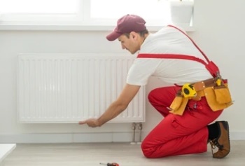 technician checking radiator from bottom