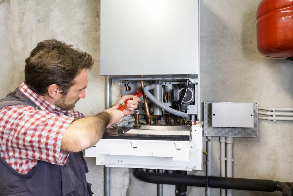 technician fixing boiler pipe