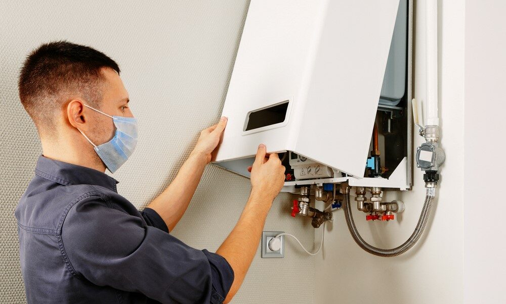 technician repairing boiler