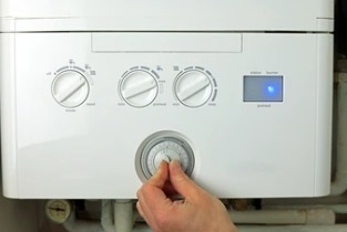 women adjusting boiler timer